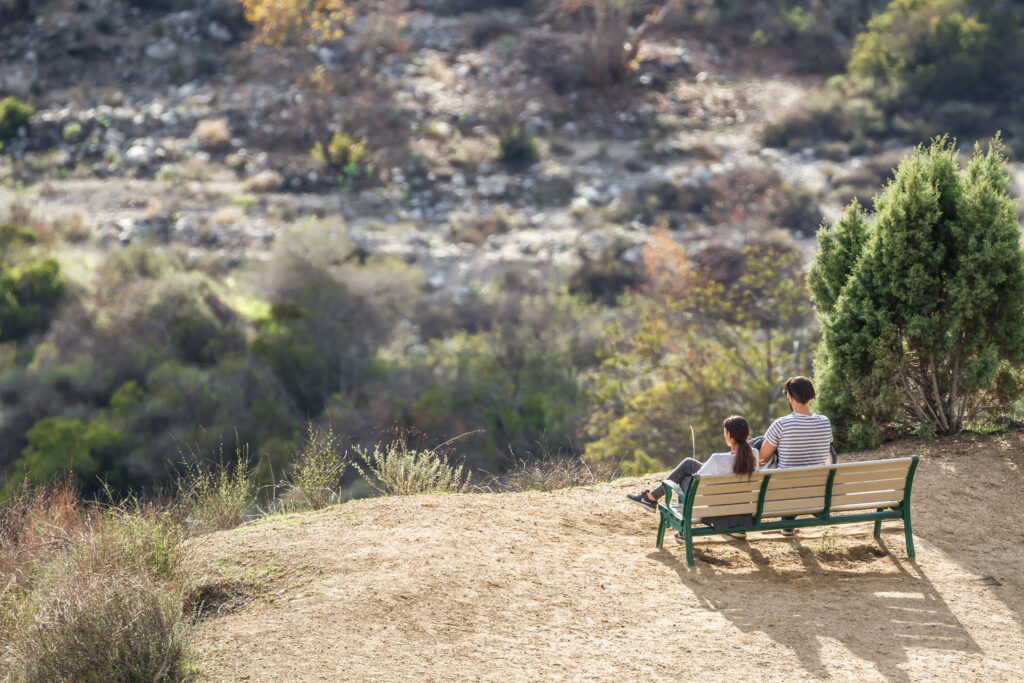 couple sitting on a bench at altadena park